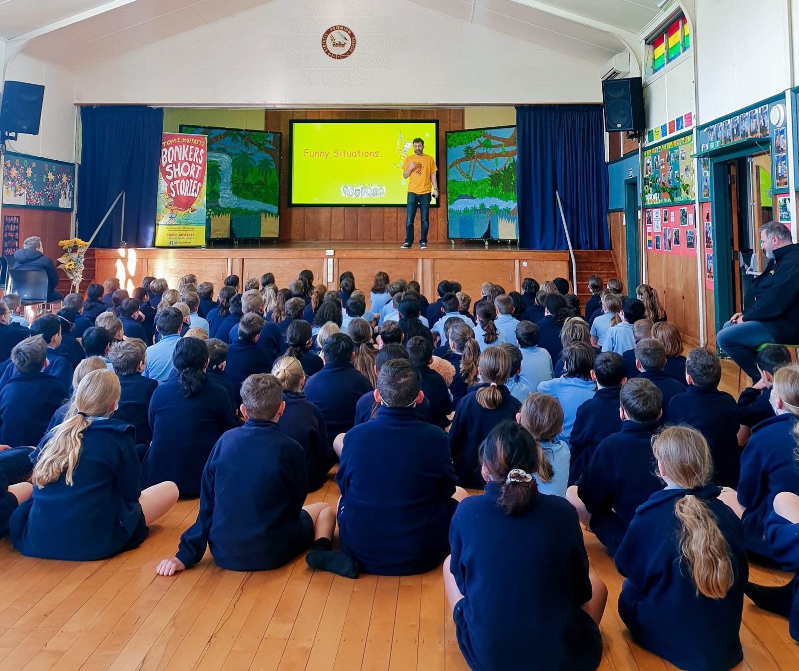 Tom E. Moffatt performing at a whole-school assembly