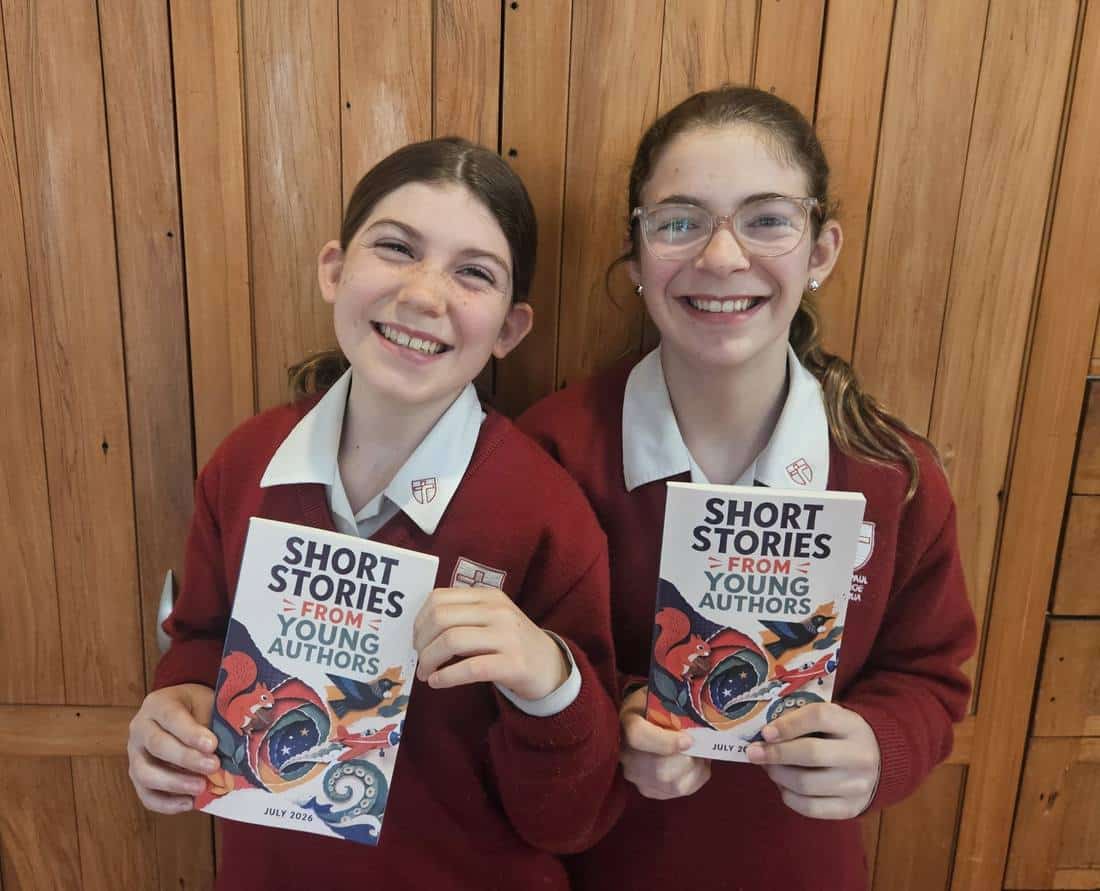 A young author holding their published paperback